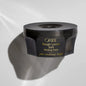 Oribe Rough Luxury Soft Molding Paste in 50ml jar, styling product with a sleek black container and white lid for textured hair styling.