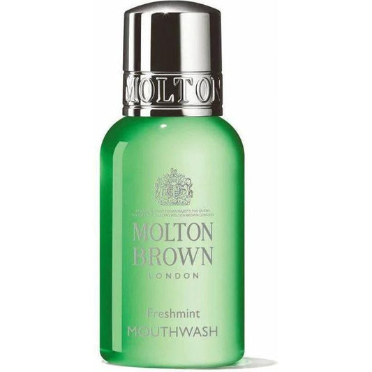 Molton Brown luxury mouthwash in a clear bottle with a blue liquid, displayed on a white background.
