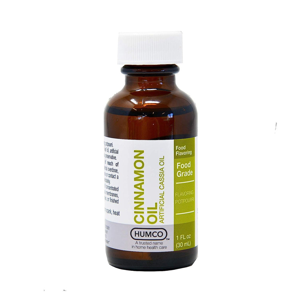 Humco Food Grade Cinnamon Oil in 1oz bottle, displayed with oil and vinegar dispensers, natural product for culinary use