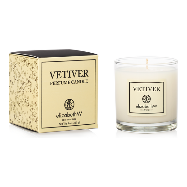 Elizabeth W Vetiver Perfume Candle in an 8oz jar, with a clear glass container and a lit wick, emitting a warm, aromatic scent.