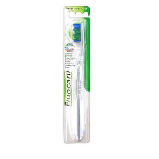 Fluocaril Complete Medium toothbrush from Pasteur Pharmacy, 0.8 oz, with soft bristles and ergonomic handle for effective brushing.