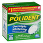 Polident Overnight Tablets for denture cleaning, shown in a clear container with packaging in the background.