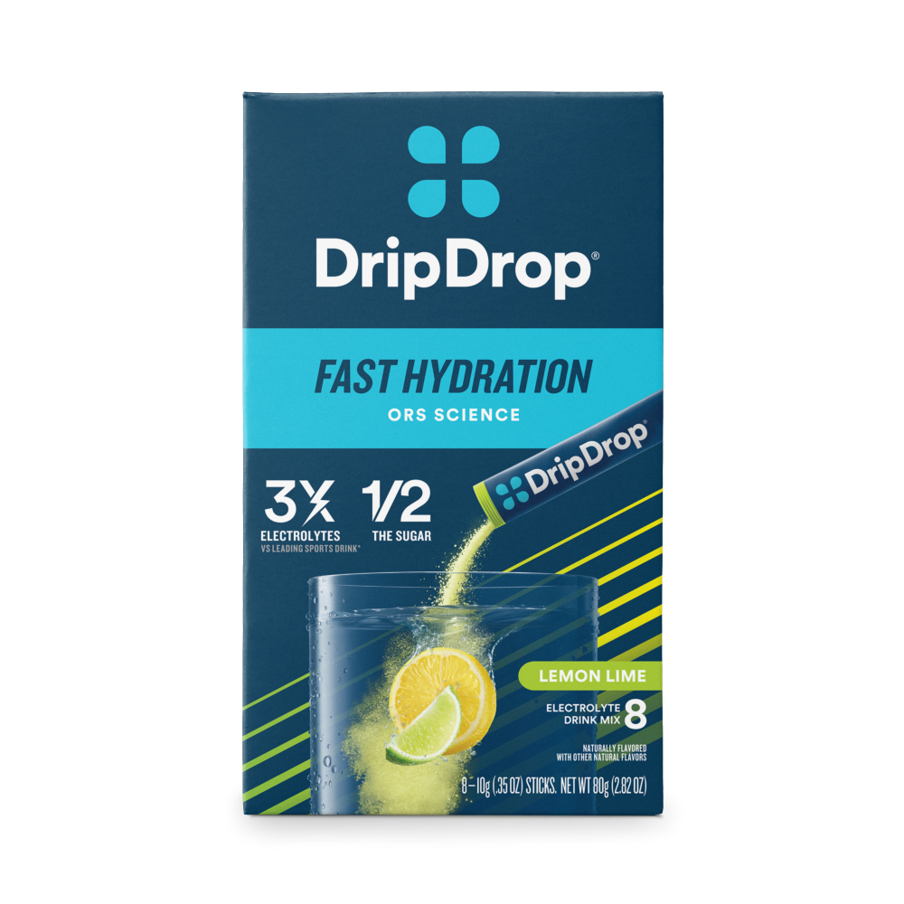 Drip Drop Lemon Lime electrolyte drink mix powder by Pasteur Pharmacy in a scoop with lemon and lime slices, ready to mix with water.