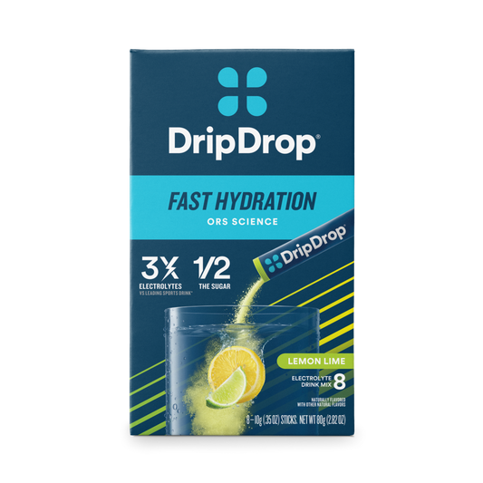 Drip Drop Lemon Lime electrolyte drink mix powder by Pasteur Pharmacy in a scoop with lemon and lime slices, ready to mix with water.