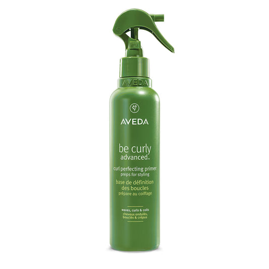 Aveda Be Curly Advanced Curl Perfecting Primer 6.7 oz bottle, lightweight hair primer for enhancing curls and reducing frizz.