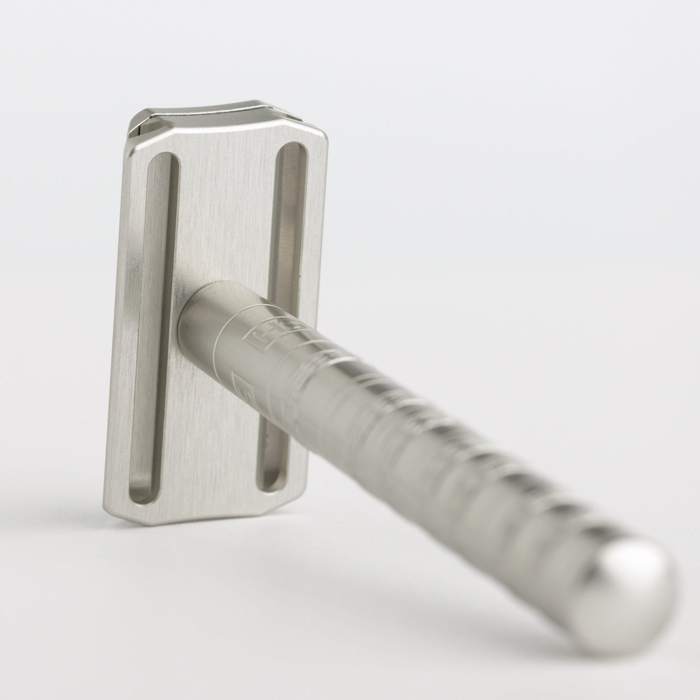 Henson Shaving AL13-V2 mild safety razor with aircraft aluminum handle, positioned on a white background.