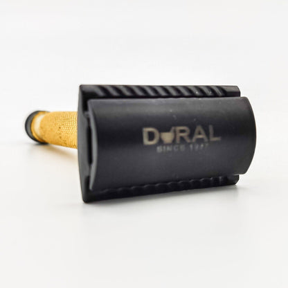 Dural Heavy Stroud Head double-edge safety razor in golden and black finish with a black pouch for storage.
