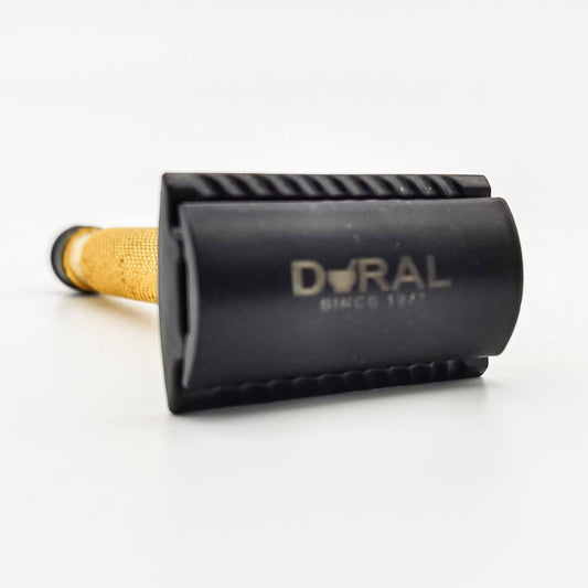 Dural Heavy Stroud Head double-edge safety razor in golden and black finish with a black pouch for storage.