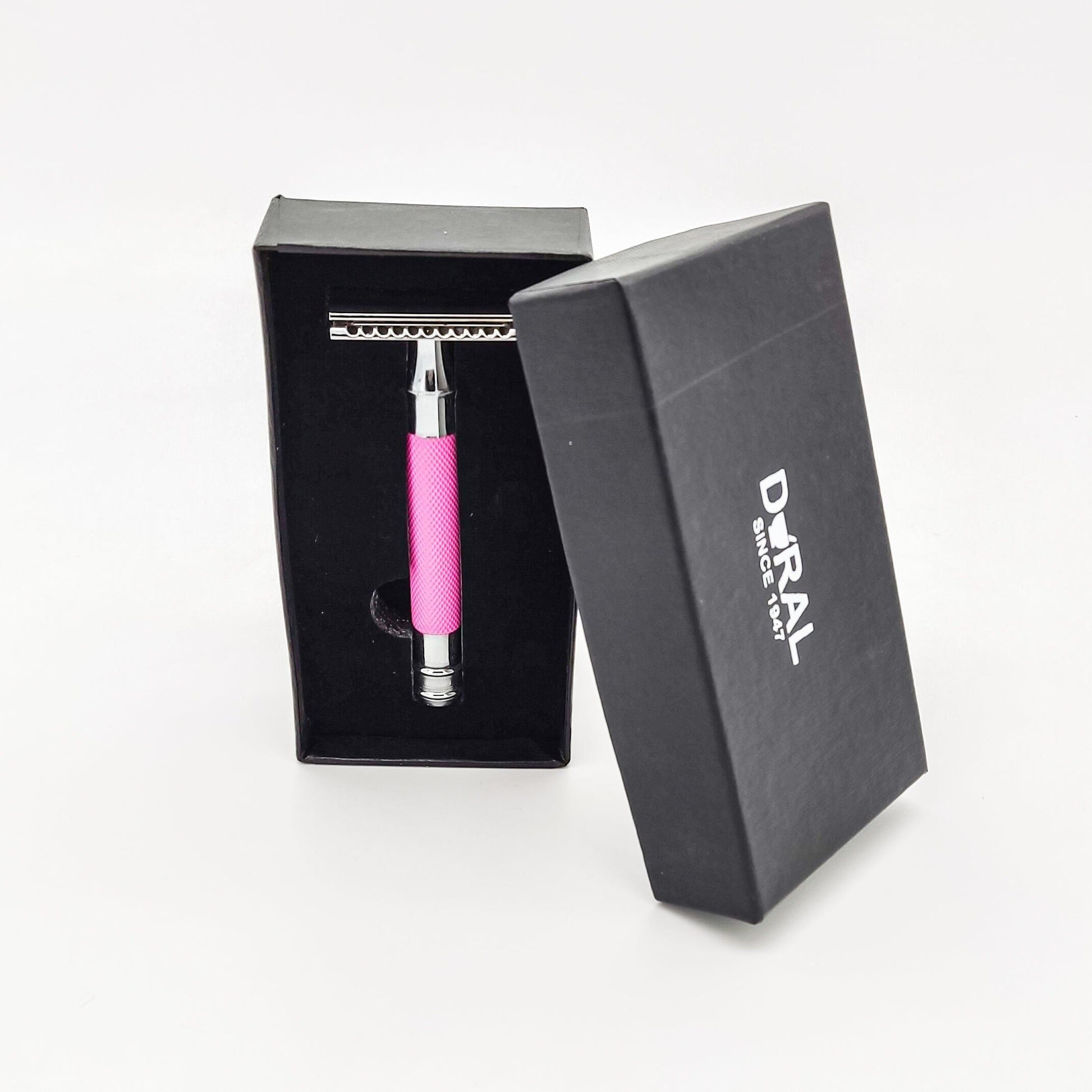 Dural Heavy Stroud Head safety razor by Pasteur Pharmacy in pink and black with a storage pouch, featuring a double-edge blade design.