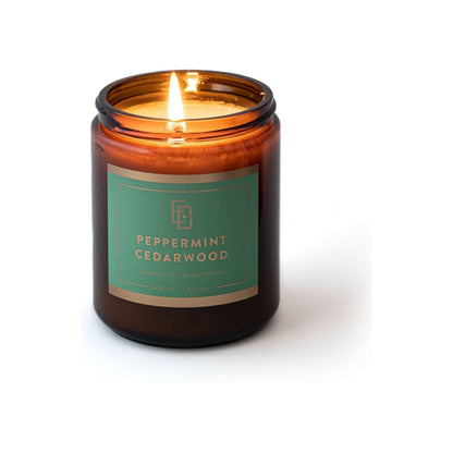 Educated Beards peppermint and cedarwood scented candle in a 9 fl oz glass jar, with a lit wick and aromatic soy wax.