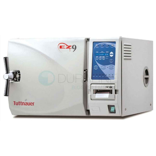 Tuttnauer EZ9 fully automatic autoclave dental sterilizer in a science laboratory setting, with digital controls and stainless steel chamber.