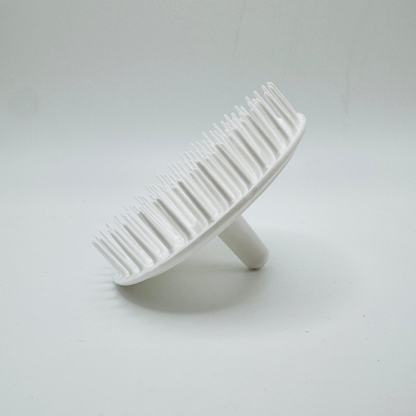 White Balloid Brosse Massage Plastic Shampoo Brush by Pasteur Pharmacy, showing the ergonomic design and bristle details.
