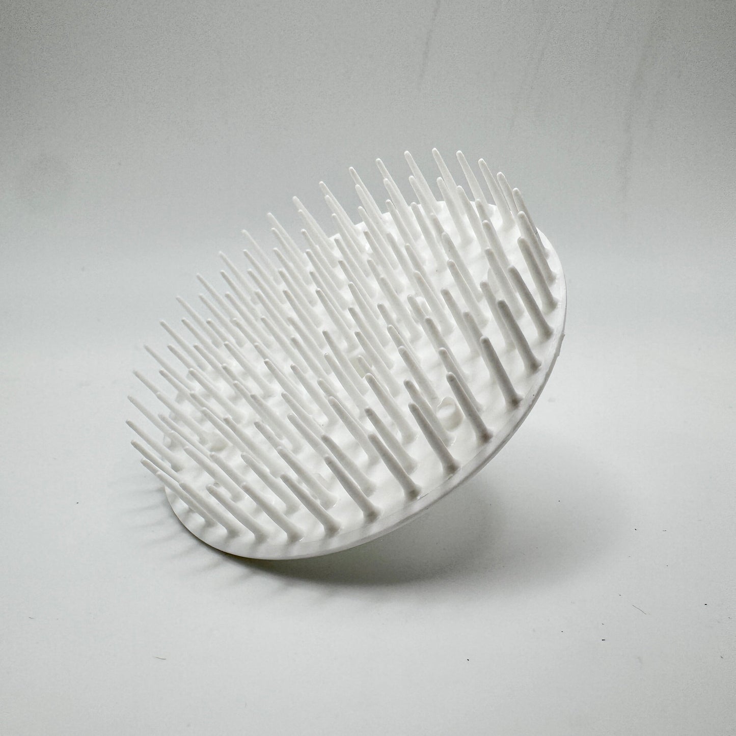 White Balloid Brosse Massage Plastic Shampoo Brush by Pasteur Pharmacy, showing a handheld shampoo brush with bristles for scalp massage.