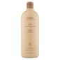 Aveda Clove Shampoo bottle, 33.8 oz, with a dark brown cap and label, displayed on a store shelf.