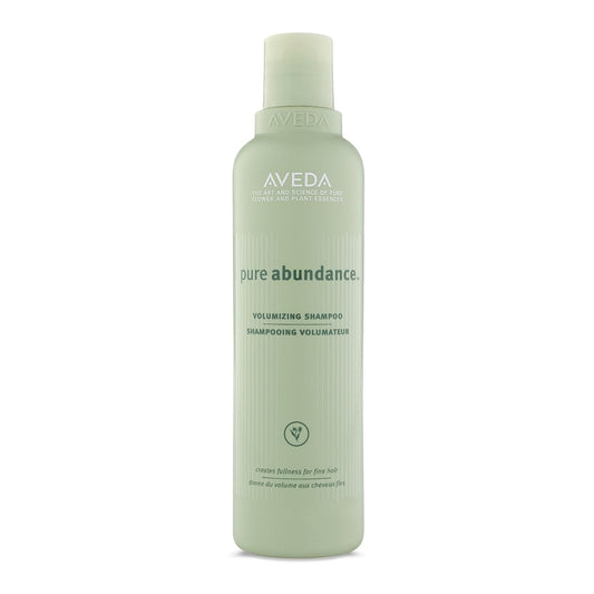 Aveda Pure Abundance Volumizing Shampoo in 6.7oz bottle, designed to add volume and fullness to hair, shown in a retail setting.