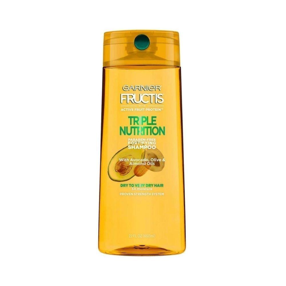Garnier Fructis Triple Nutrition Shampoo bottle for dry to very dry hair, 22 fl oz, shown in a natural hair care setting.