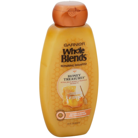 Garnier Whole Blends Honey Treasures Shampoo for damaged hair in a 650 mL bottle, featuring natural honey ingredients.