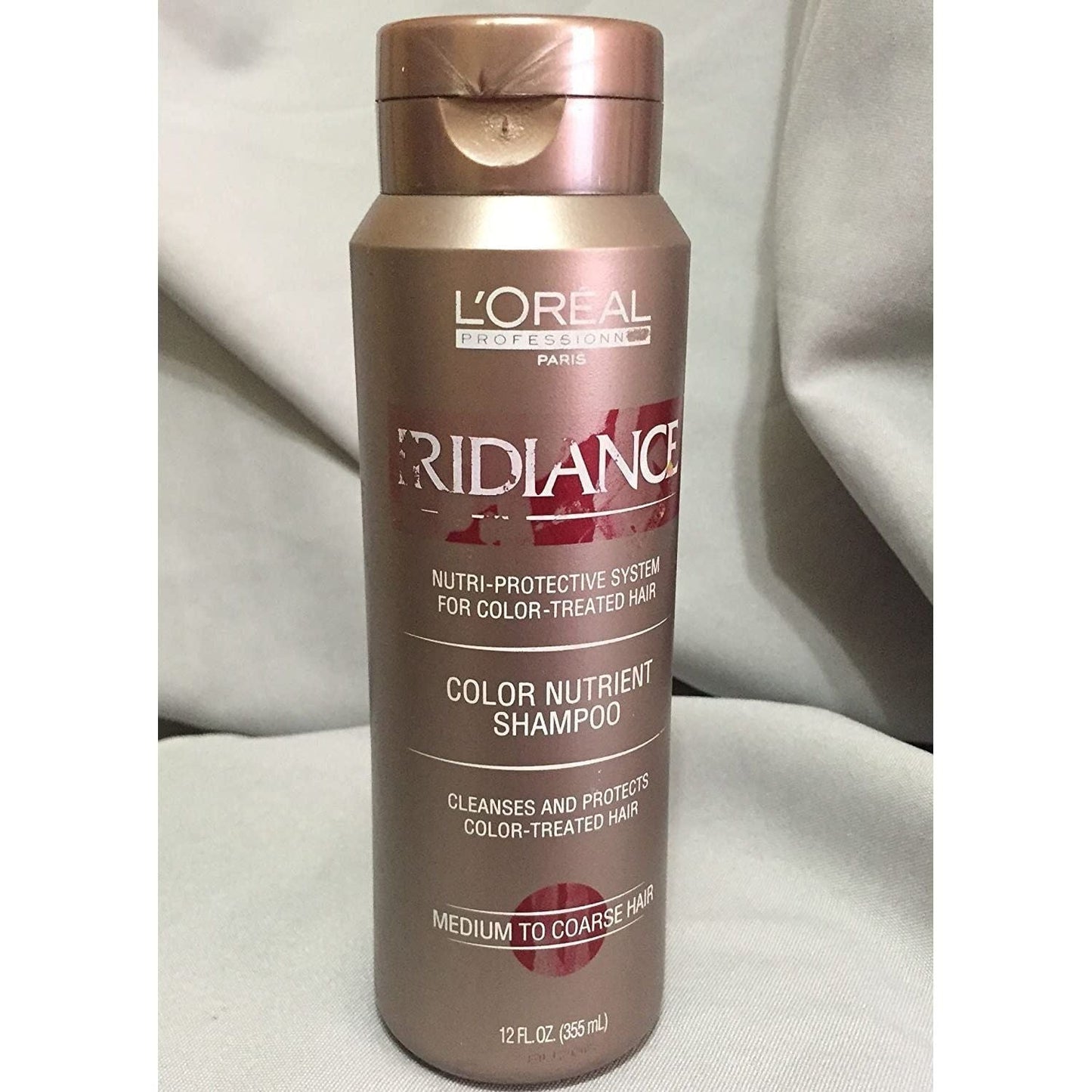 L'Oreal Iridiance Color Nutrient Shampoo in a 12 fl oz bottle, designed to nourish and enhance color-treated hair.
