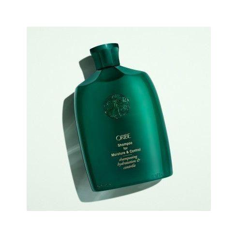 Oribe moisture and control shampoo in a 250 ml bottle, designed to hydrate and manage hair.