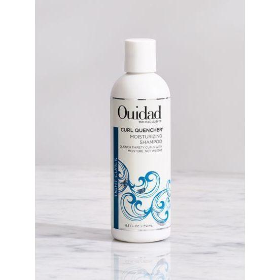 Ouidad Curl Quencher Moisturizing Shampoo bottle, 33.8 oz, with label showing brand and product details for curly hair hydration.
