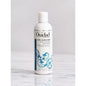 Ouidad Curl Quencher Moisturizing Shampoo bottle, 33.8 oz, with label showing brand and product details for curly hair hydration.