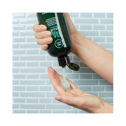 Paul Mitchell Tea Tree Special Shampoo bottle showing invigorating cleanser for scalp and hair, 10.14 oz, natural hair care product.
