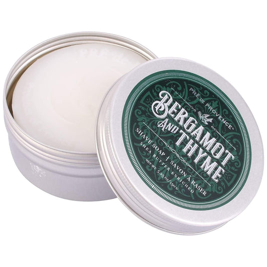 Pre De Provence Bergamot & Thyme shave soap in a metal tin, with a natural, rustic label and creamy soap visible inside.