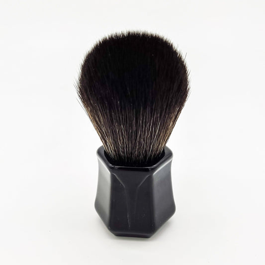 Black synthetic Darwin shaving brush by Pasteur Pharmacy with dense bristles and a sleek handle for a smooth shave.