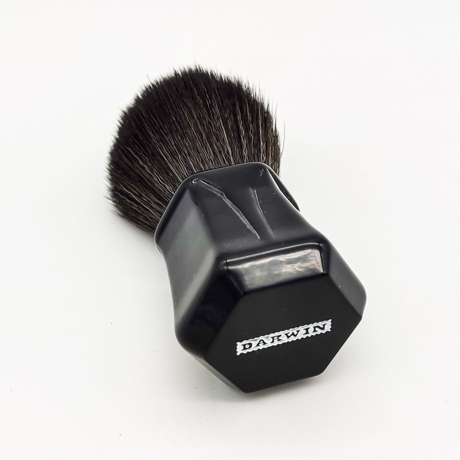 Black synthetic Darwin Shaving Brush by Pasteur Pharmacy with dense bristles and a sleek handle for a smooth shave.