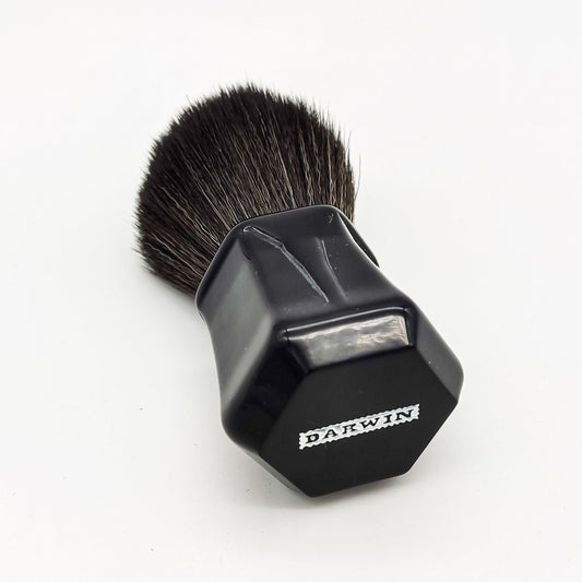 Black synthetic Darwin Shaving Brush by Pasteur Pharmacy with dense bristles and a sleek handle for a smooth shave.