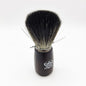 Omega shaving brush with synthetic fiber bristles, designed for a smooth shave, featuring a classic handle and detailed brush head.