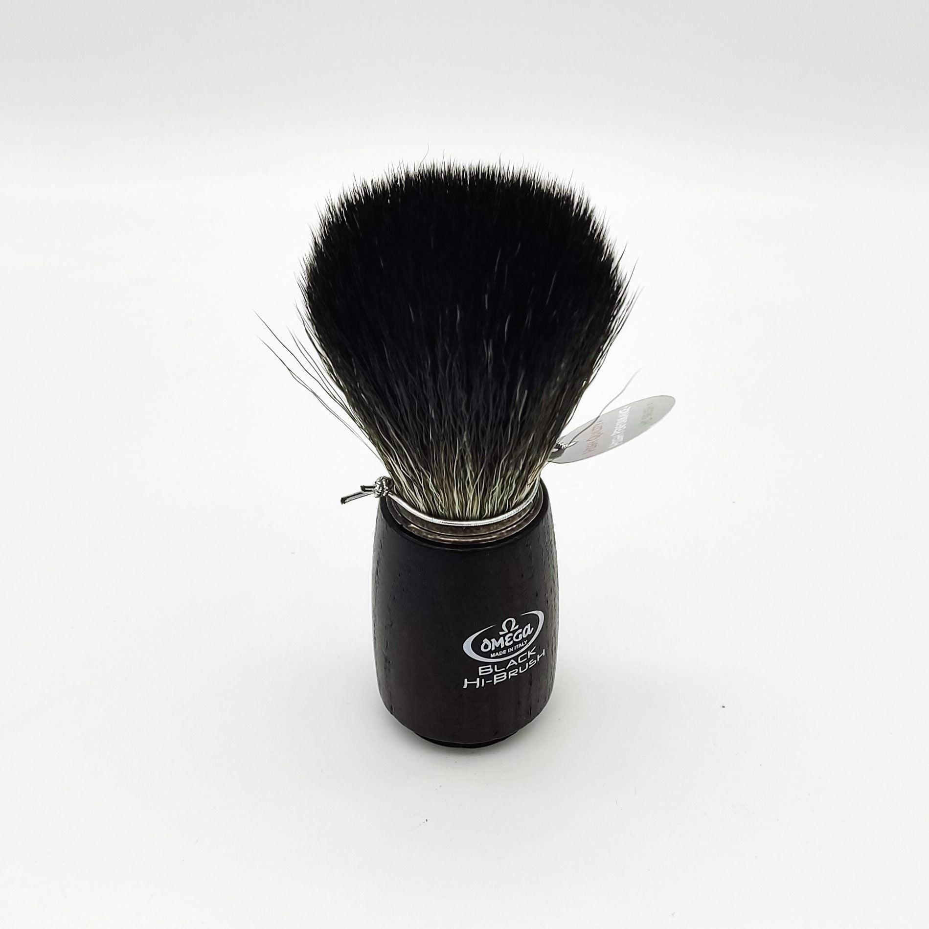 Omega shaving brush with synthetic fiber bristles, featuring a wooden handle, designed for a smooth shaving experience.