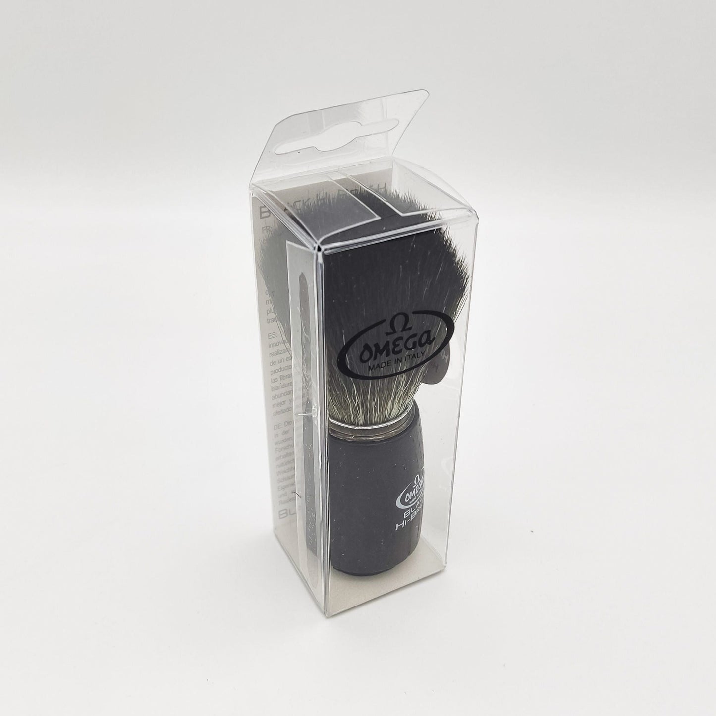 Omega shaving brush with synthetic fiber bristles, ideal for lathering and grooming, by Pasteur Pharmacy.