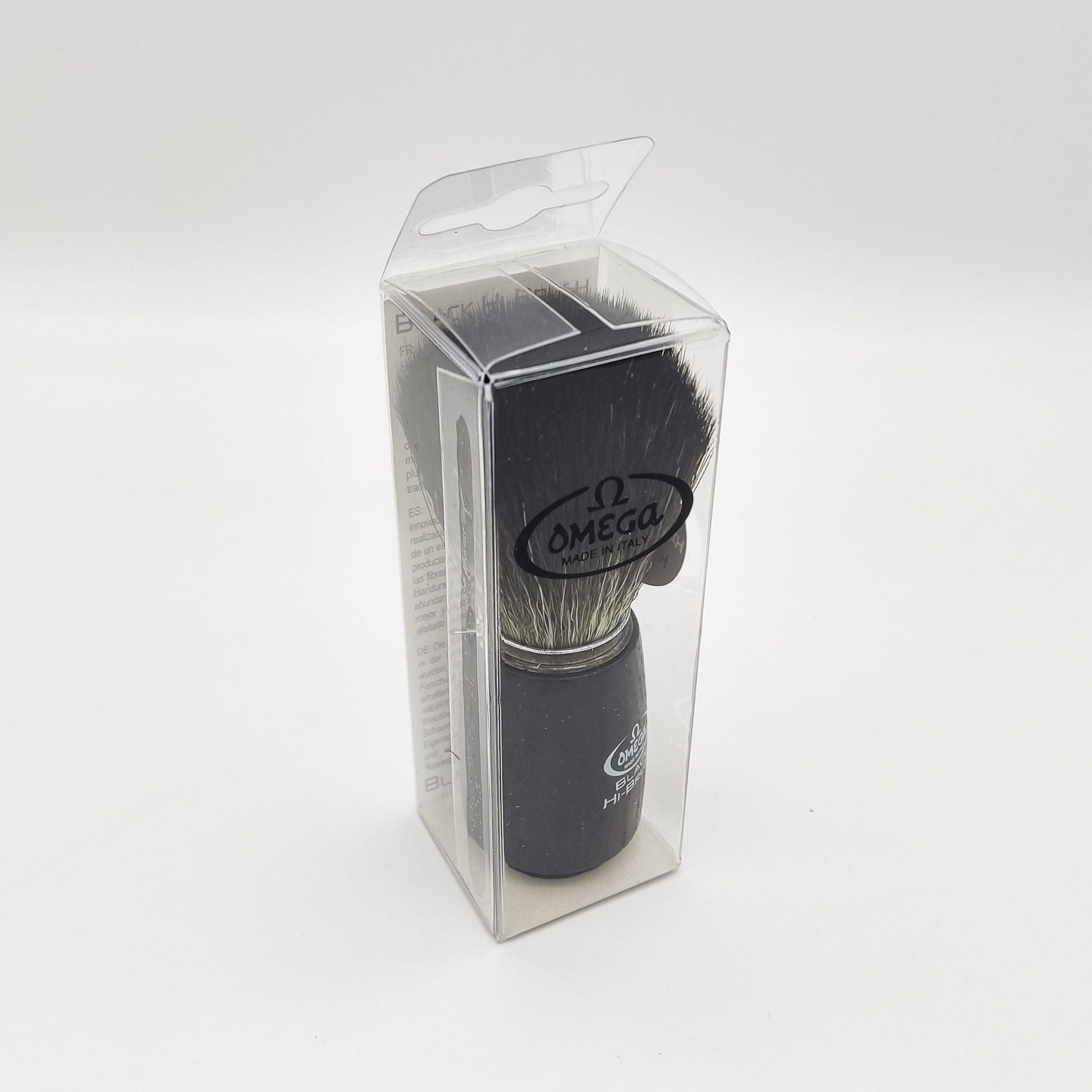 Omega shaving brush with synthetic fiber bristles, ideal for lathering and grooming, by Pasteur Pharmacy.
