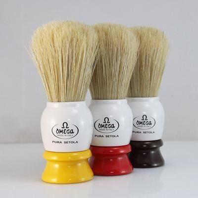 Omega Shaving Brush with variable color bristles, designed for a comfortable shave, featuring natural bristle texture and ergonomic handle.