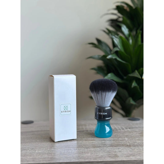 XYRISM 24mm synthetic shaving brush by Pasteur Pharmacy with soft bristles and ergonomic handle for a smooth shave.