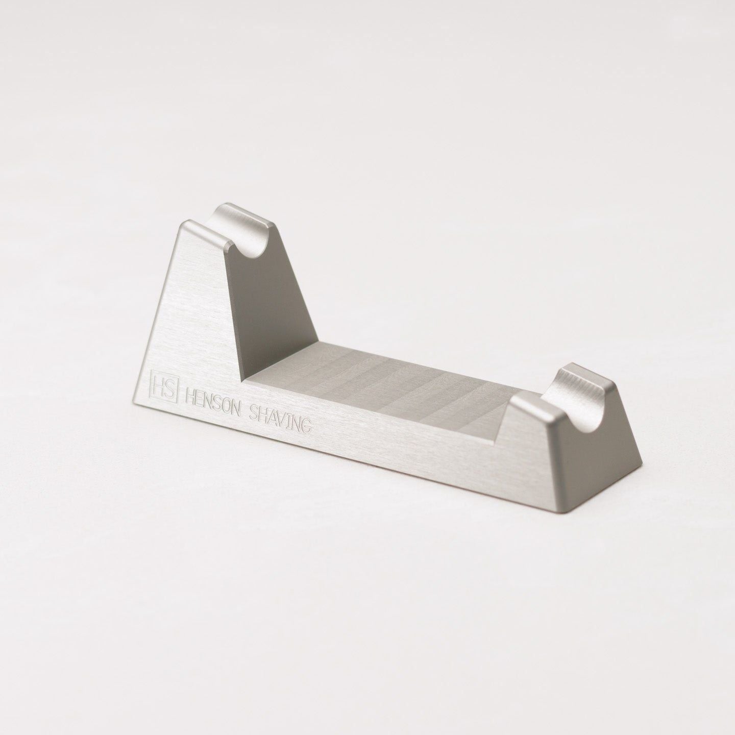 Henson Shaving Razor Stand by Pasteur Pharmacy holding a shaving razor for display or storage.