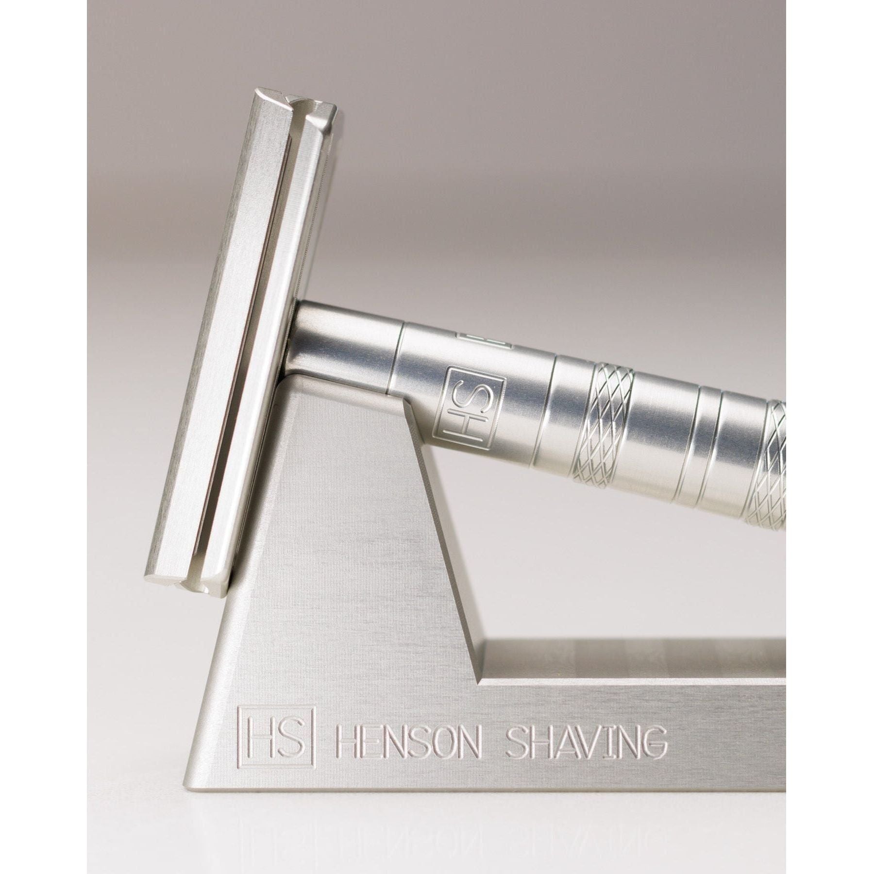 Henson Shaving Razor Stand by Pasteur Pharmacy holding a modern safety razor for organized grooming.