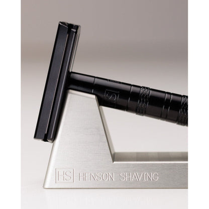 Pasteur Pharmacy Henson Shaving Razor Stand holding a razor, designed to hold and display a shaving razor securely.