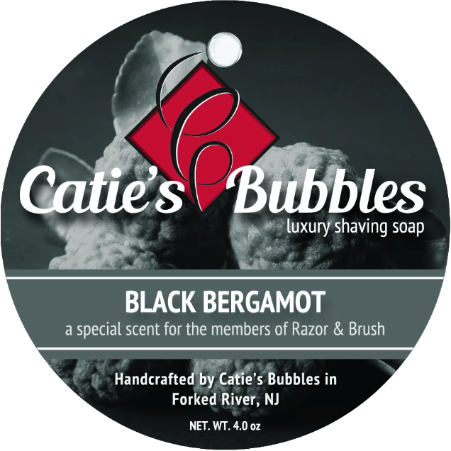 Catie's Bubbles Black Bergamot Shaving Collection shaving set with soap, brush, and accessories in a sleek package.