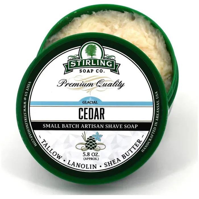 Shaving set with Stirling Soap Co. Cedar Glacial shaving soap in a container, includes a brush and razor for grooming.