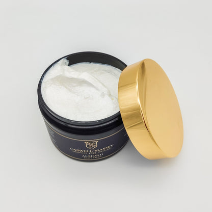 Caswell-Massey Almond Shave Soap and Cream collection with 5.2 oz shaving soap and cream, displayed in a natural setting.