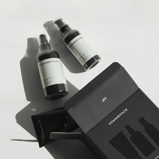 HommeFace Daily Skincare Trio set by Pasteur Pharmacy, featuring three skincare products in 17.74 oz bottles on a white background.