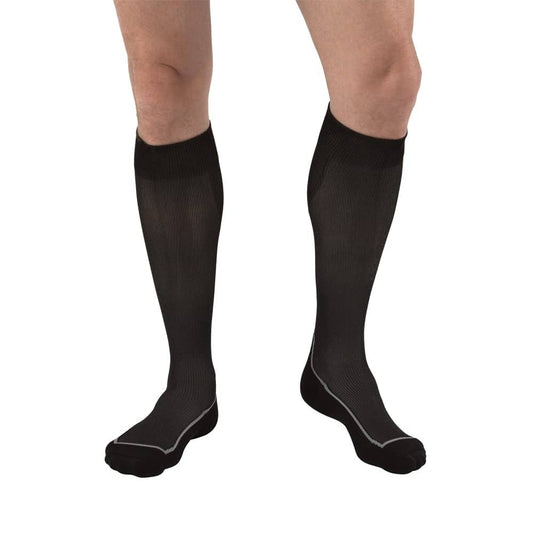 Unisex knee-high compression socks by Pasteur Pharmacy in black and grey argyle, size large, with 15-20 mmHg compression.