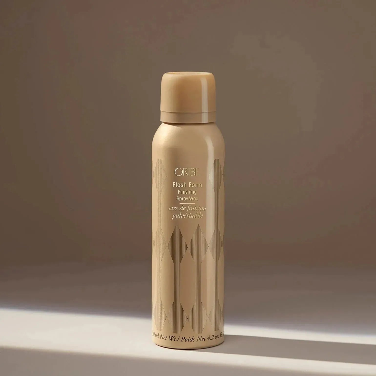 Oribe Flash Form finishing spray wax in 150ml bottle, showcasing sleek packaging and spray nozzle for styling and shine.
