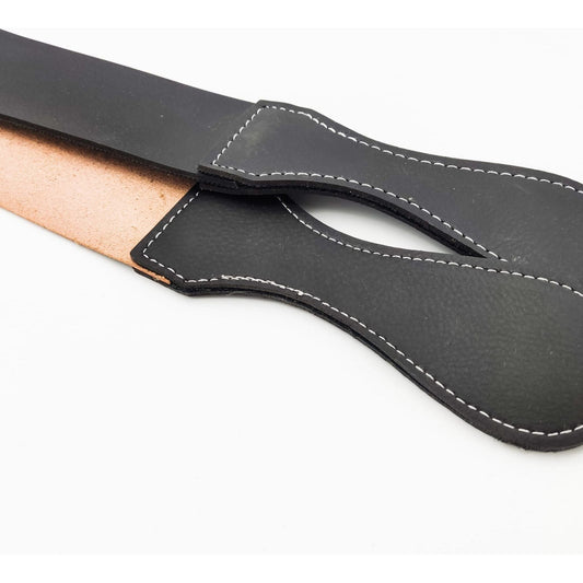 Black 20-inch Dural Straight Razor Strop leather sharpening strap from Pasteur Pharmacy, used for barber razor honing.