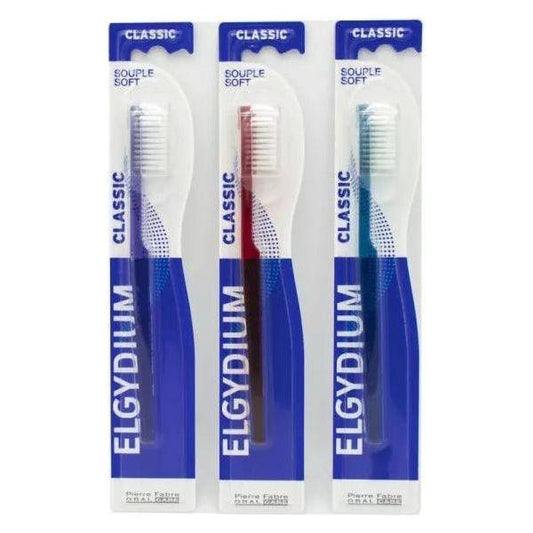 Elgydium Classic Soft Toothbrush in assorted colors, featuring a comfortable handle and gentle bristles for effective cleaning.