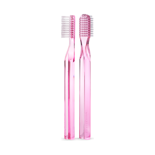 Pink Supersmile toothbrush with 45-degree ergonomic design for effective cleaning, featuring a comfortable handle.
