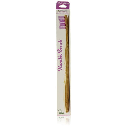 Humble Brush The Co. adult medium toothbrush with soft bristles and ergonomic handle, designed for effective oral cleaning.