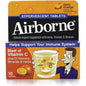 Airborne Zesty Orange effervescent tablets with vitamin C for immune support, showing a glass of dissolved supplement and orange flavor.